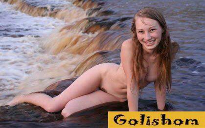 Молодые нудисты купаются и загорают на пляже